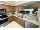 Kitchen with a breakfast bar and stainless steel appliances connects to the dining and living areas at 3810 75Th W St # 137, Bradenton, FL 34209