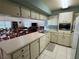 Neutral kitchen with an eat-in kitchen and a pass-through to the dining and meeting room at 3810 75Th W St # 137, Bradenton, FL 34209