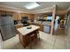Open kitchen featuring stainless steel appliances and a breakfast island with bar stool seating at 3810 75Th W St # 137, Bradenton, FL 34209