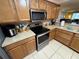 Contemporary kitchen featuring stainless steel appliances and natural wood cabinetry at 3810 75Th W St # 137, Bradenton, FL 34209