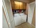 Laundry room featuring a washer, dryer, and storage shelves at 3810 75Th W St # 137, Bradenton, FL 34209