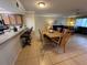 Inviting living room and dining area features tile flooring and seating at the kitchen counter at 3810 75Th W St # 137, Bradenton, FL 34209