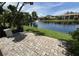 Paver patio overlooks the water with fountain in this complex with lush landscaping and clear blue skies at 3810 75Th W St # 137, Bradenton, FL 34209