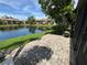 Paver patio and water view from a unit in this complex with lush landscaping and clear blue skies at 3810 75Th W St # 137, Bradenton, FL 34209