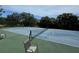 A well-maintained tennis court with surrounding trees provides residents an opportunity for recreation and exercise at 3810 75Th W St # 137, Bradenton, FL 34209