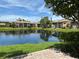 View of the water from the paver patio of a unit in this complex with lush landscaping and clear blue skies at 3810 75Th W St # 137, Bradenton, FL 34209