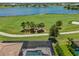 Aerial view of home showcasing pool, golf course, and scenic lake views at 3936 Santa Caterina Blvd, Bradenton, FL 34211
