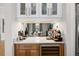 Stylish bar area with custom cabinetry, wine storage, and elegant countertop at 3936 Santa Caterina Blvd, Bradenton, FL 34211