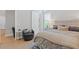 Stylized bedroom featuring a barn door, light floors, and bright natural light at 3936 Santa Caterina Blvd, Bradenton, FL 34211