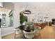 Open-concept dining area with modern lighting and views of the spacious kitchen and living room at 3936 Santa Caterina Blvd, Bradenton, FL 34211