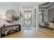 Bright foyer with hardwood floors, chandelier, and a view of the dining area and front door at 3936 Santa Caterina Blvd, Bradenton, FL 34211