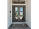 Close-up of elegant double front doors with glass panels and a stylish welcome mat at 3936 Santa Caterina Blvd, Bradenton, FL 34211