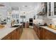 Bright, modern kitchen with stainless appliances, white cabinets, and a center island at 3936 Santa Caterina Blvd, Bradenton, FL 34211