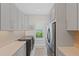 Well-appointed laundry room featuring storage cabinets, counter space, and modern appliances at 3936 Santa Caterina Blvd, Bradenton, FL 34211
