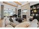 Spacious living room with stone fireplace, wooden beams, and elegant decor and grand piano at 3936 Santa Caterina Blvd, Bradenton, FL 34211