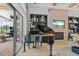 Elegant living room featuring a grand piano, fireplace, and open floorplan at 3936 Santa Caterina Blvd, Bradenton, FL 34211