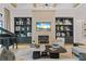 Cozy living room with a stone fireplace, built-in shelving, and a stylish piano at 3936 Santa Caterina Blvd, Bradenton, FL 34211