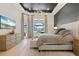 Luxurious main bedroom features a tray ceiling with chandelier, a TV and views of the pool at 3936 Santa Caterina Blvd, Bradenton, FL 34211