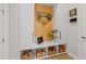 Convenient mudroom featuring storage and a bench with storage baskets below at 3936 Santa Caterina Blvd, Bradenton, FL 34211
