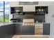 Modern outdoor kitchen featuring stainless steel appliances and sleek cabinetry at 3936 Santa Caterina Blvd, Bradenton, FL 34211