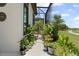 Charming patio featuring various potted plants and greenery, with a view of the golf course beyond at 3936 Santa Caterina Blvd, Bradenton, FL 34211