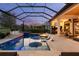 Stunning pool area with sunken lounge chairs, a fire pit, a spa, and an outdoor kitchen perfect for entertaining at 3936 Santa Caterina Blvd, Bradenton, FL 34211