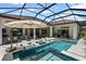 Resort-style pool area with in-pool loungers, spa, umbrella, outdoor kitchen, and a comfortable seating arrangement at 3936 Santa Caterina Blvd, Bradenton, FL 34211