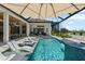 Stunning backyard pool with a luxurious lounge area and golf course views at 3936 Santa Caterina Blvd, Bradenton, FL 34211