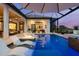 Luxurious pool area with in-water loungers, a fire pit, a spa, and an outdoor kitchen, perfect for relaxation at 3936 Santa Caterina Blvd, Bradenton, FL 34211
