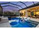 Elegant pool area with sunken lounge chairs, a fire pit, a spa, an outdoor kitchen, and comfortable seating spaces at 3936 Santa Caterina Blvd, Bradenton, FL 34211