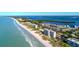 Expansive aerial view showcasing the luxurious beachside condos and the pristine shoreline of the coastline at 4380 Exeter Dr # 204, Longboat Key, FL 34228
