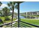 Inviting balcony view overlooking landscaped grounds, a canal and condominium buildings at 4380 Exeter Dr # 204, Longboat Key, FL 34228