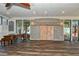 Spacious ballroom with wood floors, ceiling beams, barn doors, and views of the waterfront at 4380 Exeter Dr # 204, Longboat Key, FL 34228