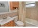 Cozy bathroom featuring a vanity, toilet, tub with shower curtain, and tiled walls at 4380 Exeter Dr # 204, Longboat Key, FL 34228