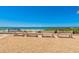 Picturesque beach view featuring benches overlooking the ocean and beautiful blue sky at 4380 Exeter Dr # 204, Longboat Key, FL 34228