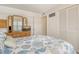 Bedroom featuring beach themed bedding, a large dresser, and a window with an outdoor view at 4380 Exeter Dr # 204, Longboat Key, FL 34228