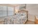 Cozy bedroom with beach themed decor, a plush bed, and a window with natural light at 4380 Exeter Dr # 204, Longboat Key, FL 34228