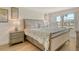 Comfortable bedroom featuring an updated bed set and a bright window with outdoor view at 4380 Exeter Dr # 204, Longboat Key, FL 34228