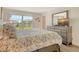 Bright bedroom featuring a water view, side table and dresser with a large mirror at 4380 Exeter Dr # 204, Longboat Key, FL 34228
