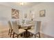 Elegant dining room with a glass-top table and seating for six, perfect for entertaining at 4380 Exeter Dr # 204, Longboat Key, FL 34228