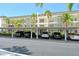Low-rise condos showcase covered parking, complemented by swaying palm trees, creating a welcoming coastal ambiance at 4380 Exeter Dr # 204, Longboat Key, FL 34228