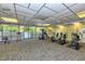 Bright gym with multiple workout machines, mirrored walls, and large windows overlooking greenery at 4380 Exeter Dr # 204, Longboat Key, FL 34228