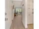 Bright hallway with wood-look floors, white trim, and cabinets leads to a living area with a view at 4380 Exeter Dr # 204, Longboat Key, FL 34228