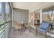 Screened in lanai with comfortable chairs and views of condos and lush landscaping at 4380 Exeter Dr # 204, Longboat Key, FL 34228