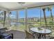 This screened lanai features outdoor seating and scenic views of the bay with boat docks at 4380 Exeter Dr # 204, Longboat Key, FL 34228