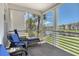Cozy lanai with bay views; perfect for relaxing with outdoor seating, boats, and greenery at 4380 Exeter Dr # 204, Longboat Key, FL 34228