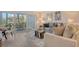 Cozy living room with sliders to lanai, comfortable seating and neutral decor provide a relaxing atmosphere at 4380 Exeter Dr # 204, Longboat Key, FL 34228