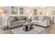 Comfortable living room with modern sofas, stylish area rug, and contemporary decor at 4380 Exeter Dr # 204, Longboat Key, FL 34228