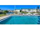 Community pool with lounge chairs and views of the canal and neighborhood buildings at 4380 Exeter Dr # 204, Longboat Key, FL 34228