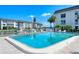 Community pool featuring clear blue water, ladder access, and views of the canal at 4380 Exeter Dr # 204, Longboat Key, FL 34228